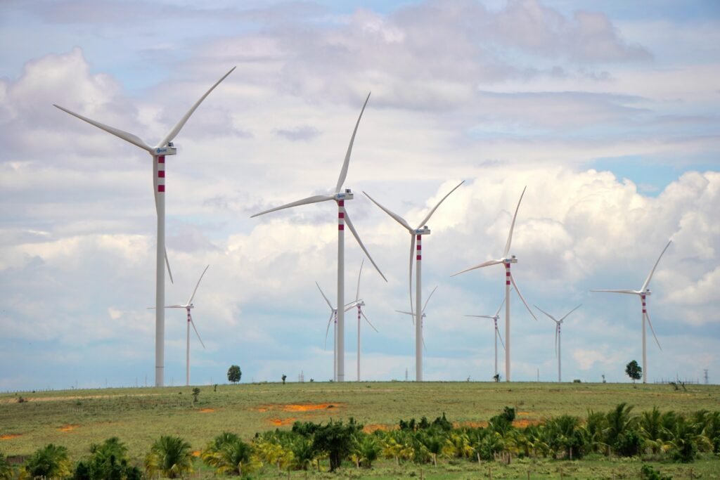 A scenic landscape featuring multiple wind turbines against a cloudy sky, symbolizing renewable energy.
